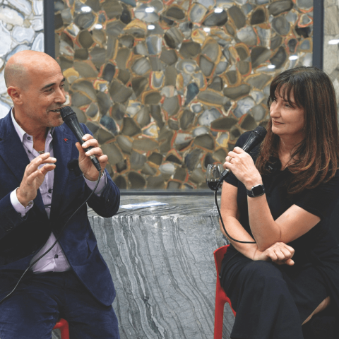 a man and a woman are holding microphones and talking