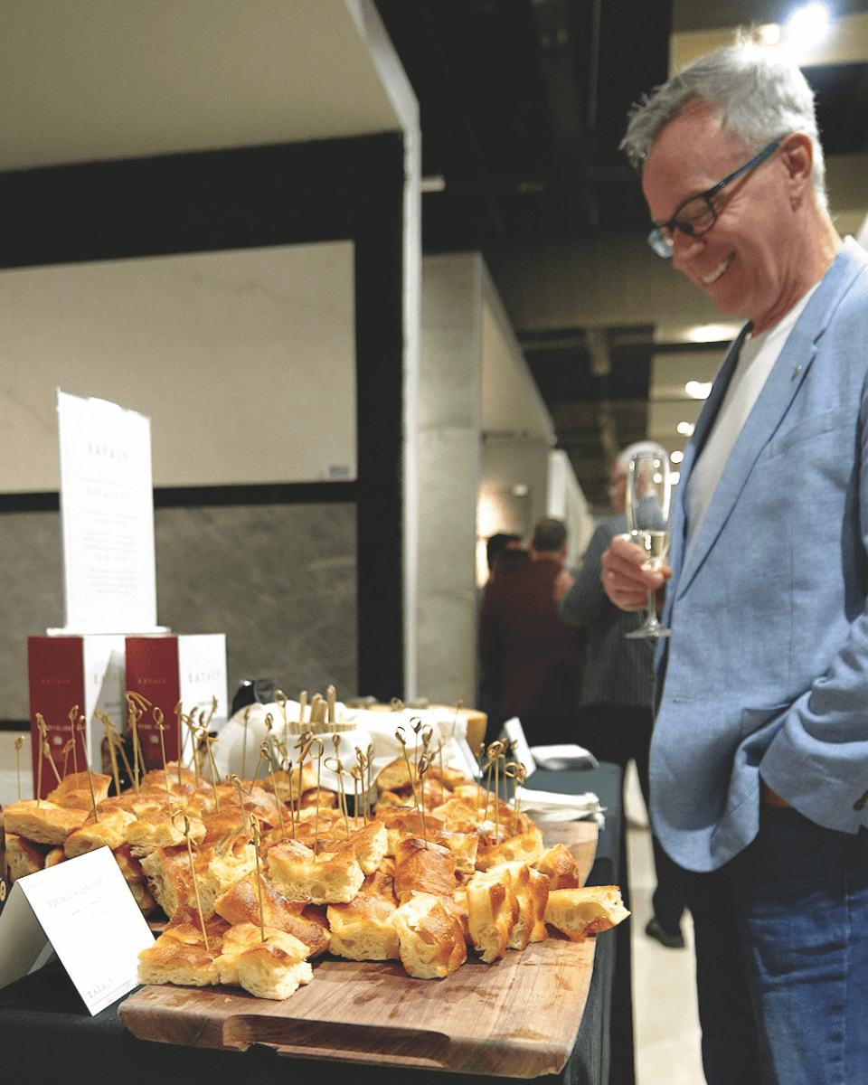 man standing beside focaccia