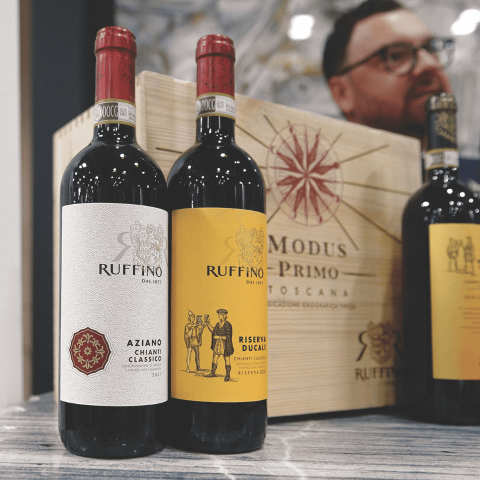 Bottles of red wine in front of a wooden box