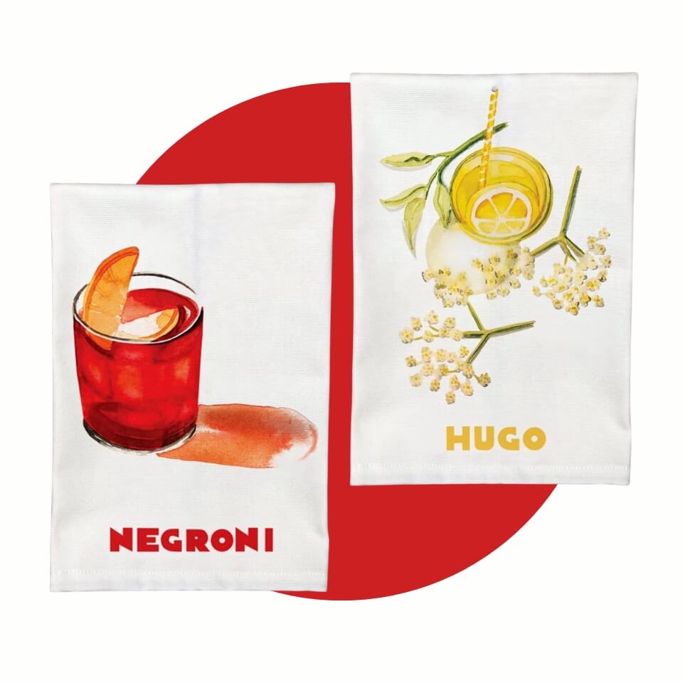 Two white tea towels, one with a Negroni illustration and one with an Hugo spritz illustration, over a red circle