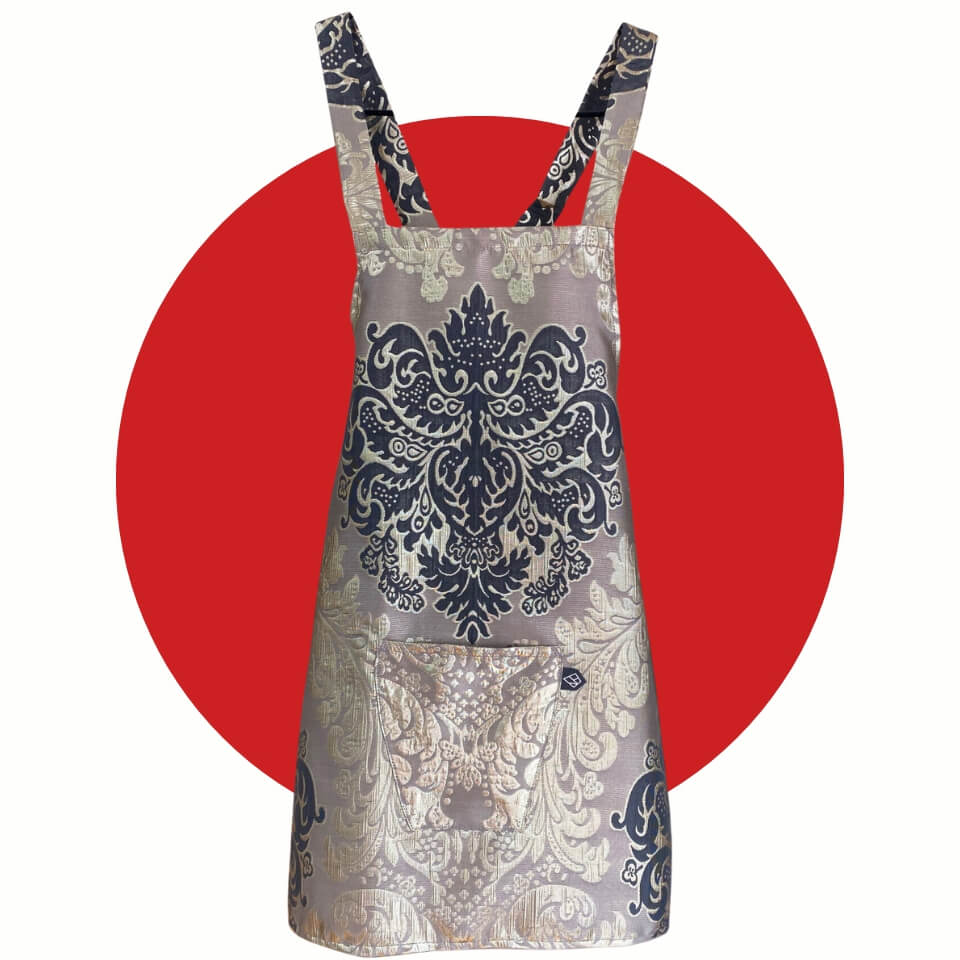 A damask-patterned apron over a red circle
