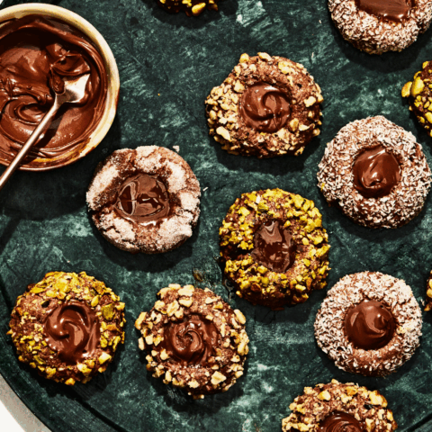 Delicious chocolate thumbprint cookies with chocolate, nutella and dulce de lece filling.