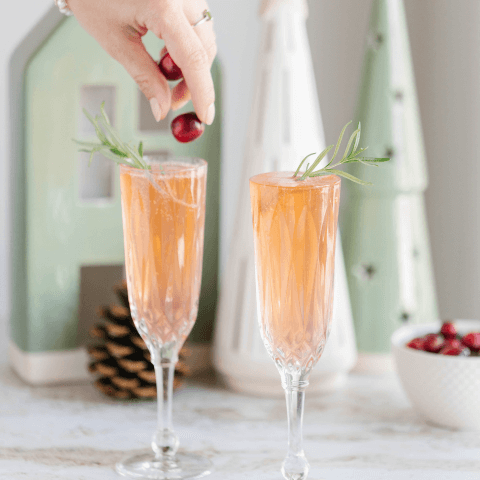 two champagne glasses with cranberry sparkling cocktail