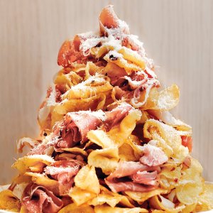 Prosciutto potato chip tower drizzled with hot honey and Parmesan