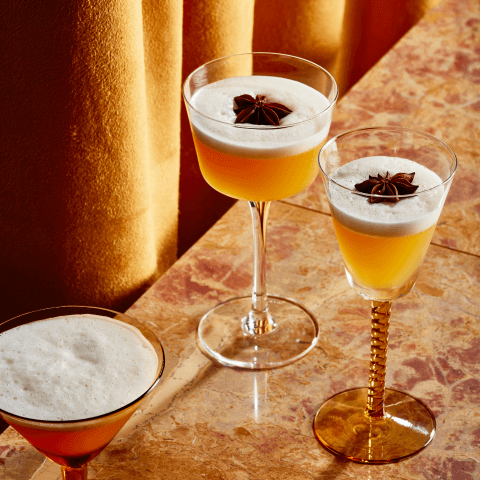 two cocktails with star anise