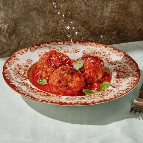 Bowl of large meatballs in homemade red sauce