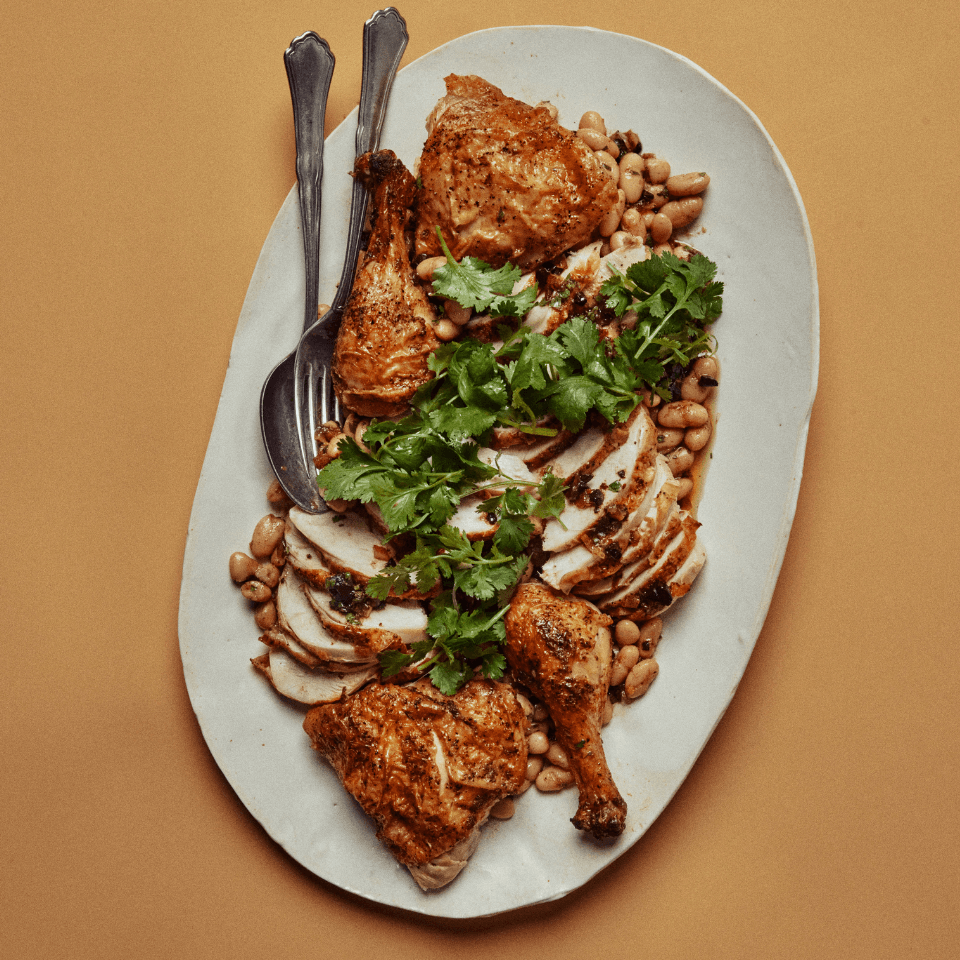 A recipe for store-bought rotisserie chicken and herbed beans, zhoug and cilantro