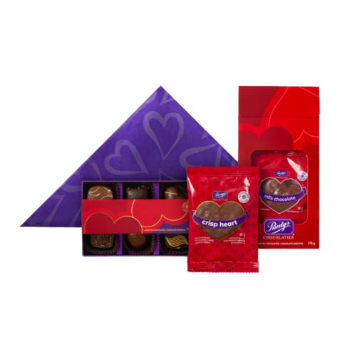 Purple triangular box, box of six chocolate truffles and two red packages of Valentine's Day chocolates.