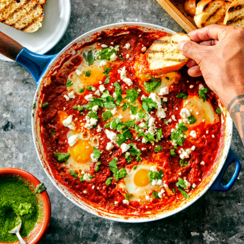Poached runny eggs in a bright red curried tomato sauce, topped with feta and green onion. Served with grilled bread and cilantro pesto.