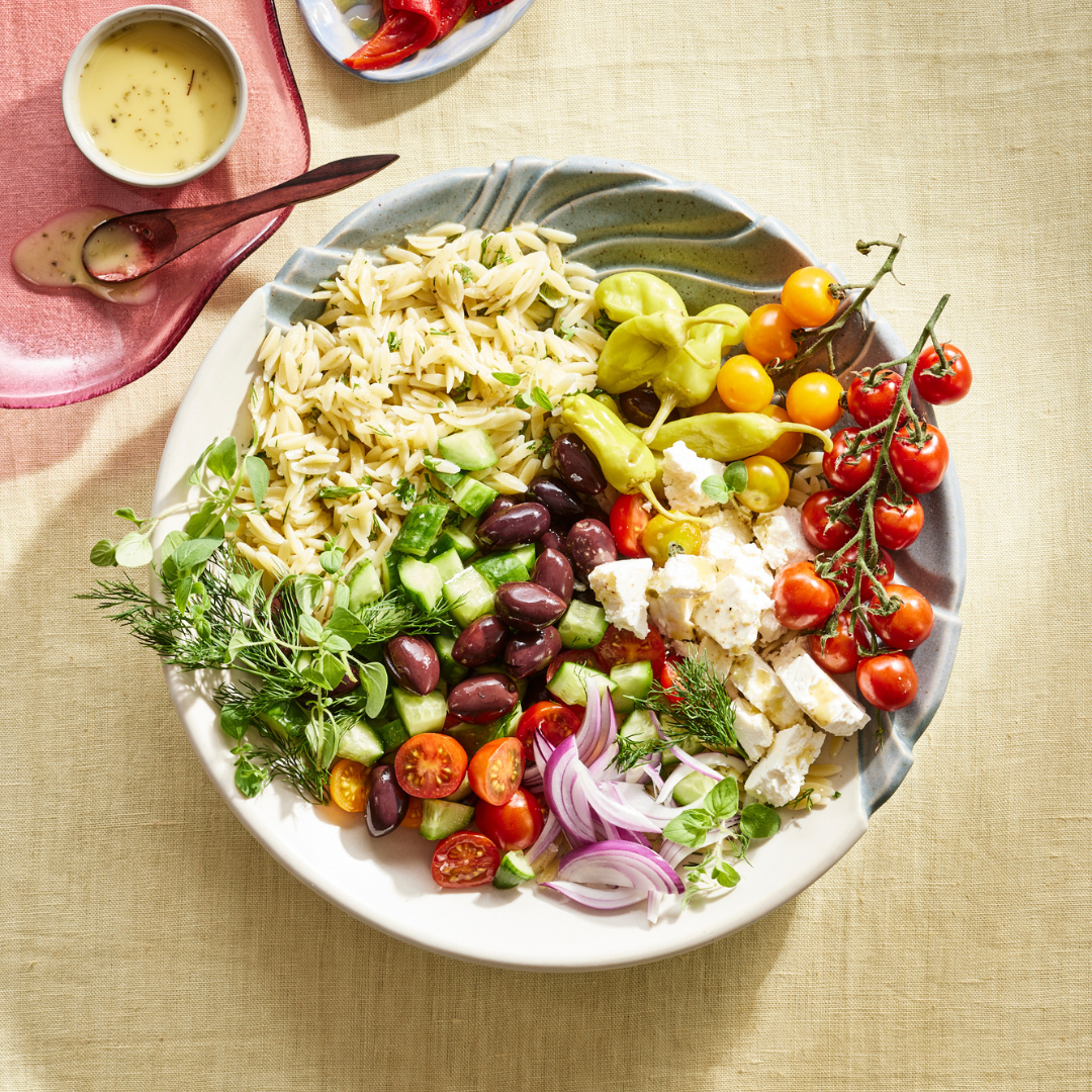 Greek orzo salad with bright vegetables & dressing on the side