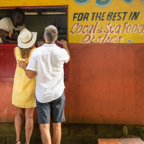 Man and woman enjoying ordering from a roadside food truck