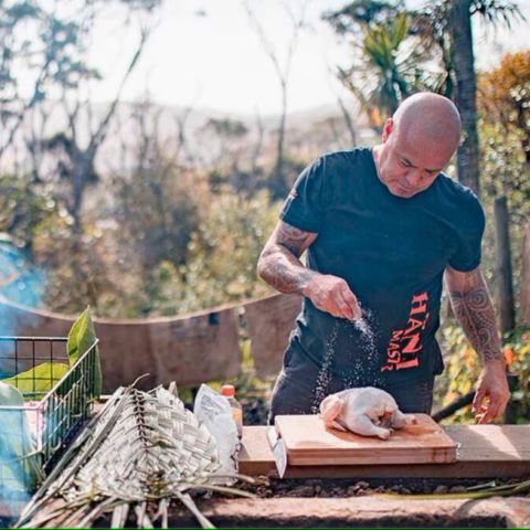 Rewi Spraggon New Zealand’s Hāngi master cooking chicken as part of Maori Food and Wine Experiences
