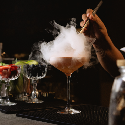 Stunning example of mixology at with dry ice creating smoke in a glass