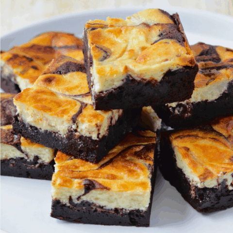 A stack of goat cheesecake brownies with a rich chocolate base and creamy cheesecake filling, The Goat Cheese Brownies with a creamy swirl