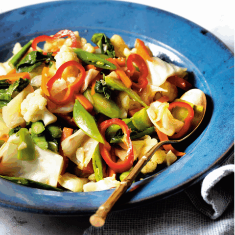 Beautiful blue bowl of a Thai mixed-veggie stir fry