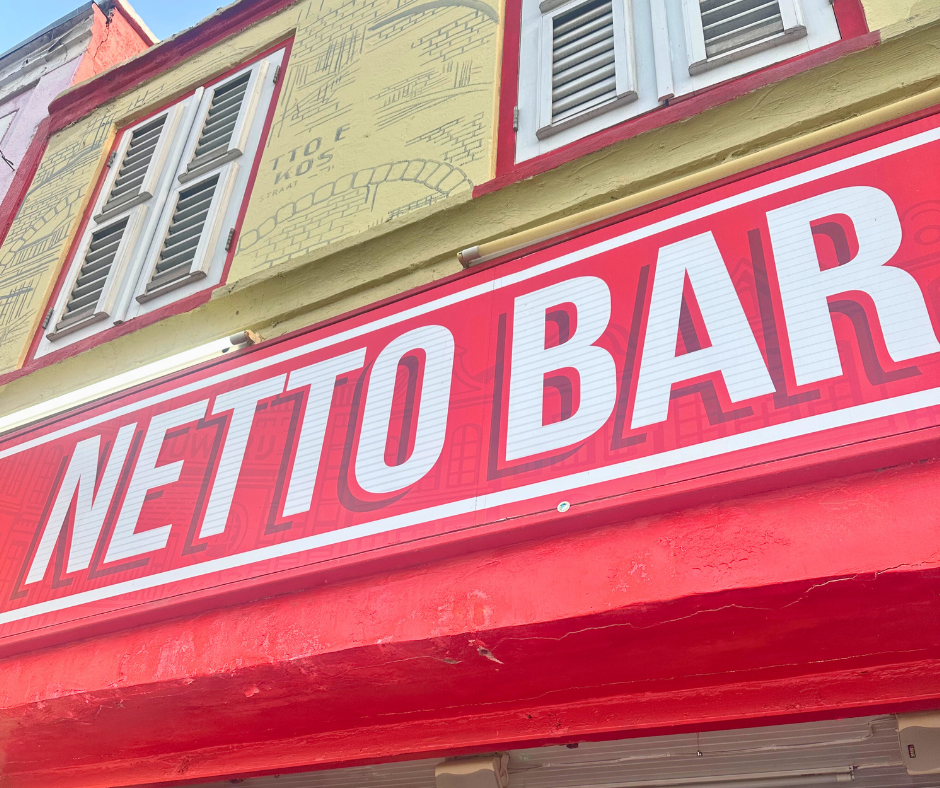 Red and white painted storefront of Netto Bar, Curaçao