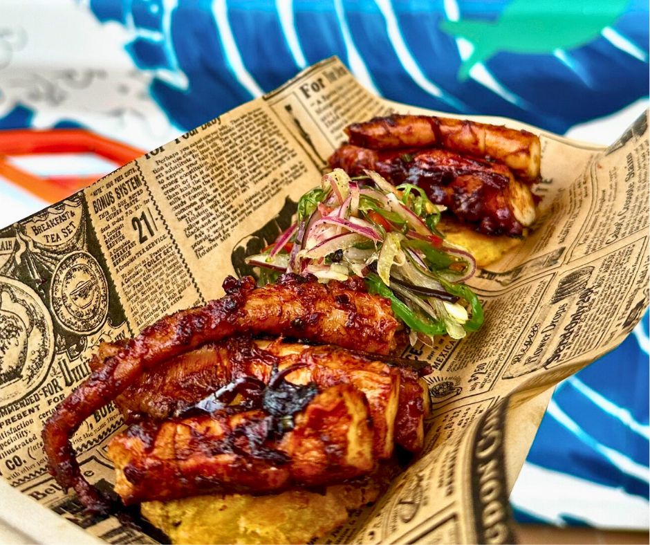 Pulpo a la Plancha from Pasawá Box Eatery served in newspaper