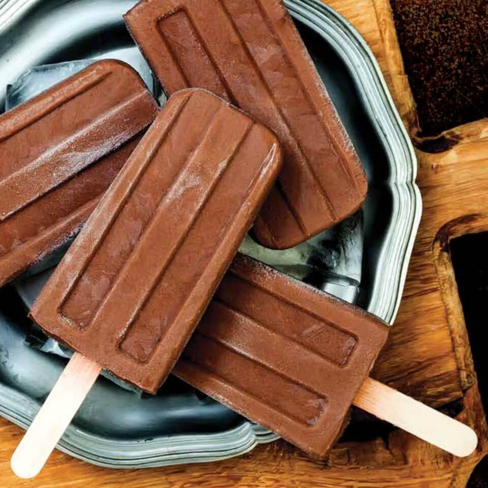 Four chocolate popsicles stacked atop each other.