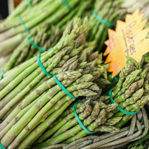 a basket of asparagus at a farmer's market in Quebec