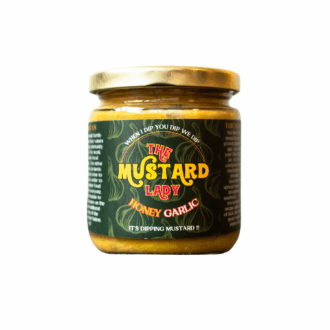 Clear jar of yellow honey garlic mustard from The Mustard Lady.