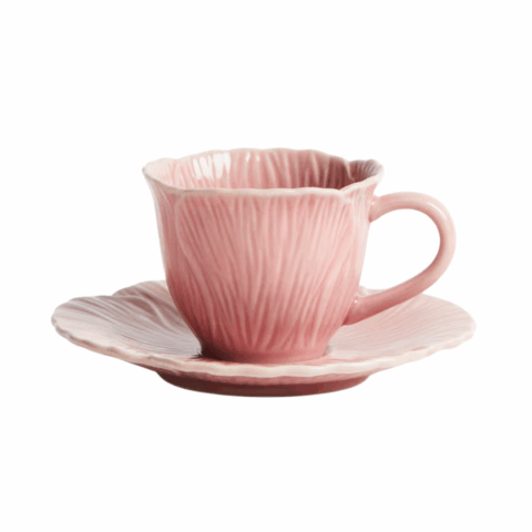 A pink espresso cup that looks like flower petals.