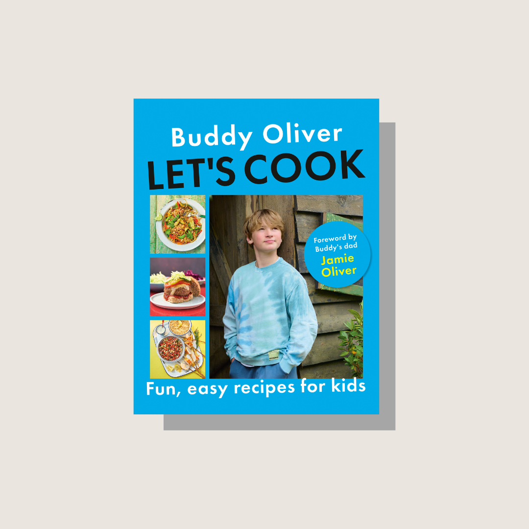 The cover of the Let's Cook cookbook on a beige background. 