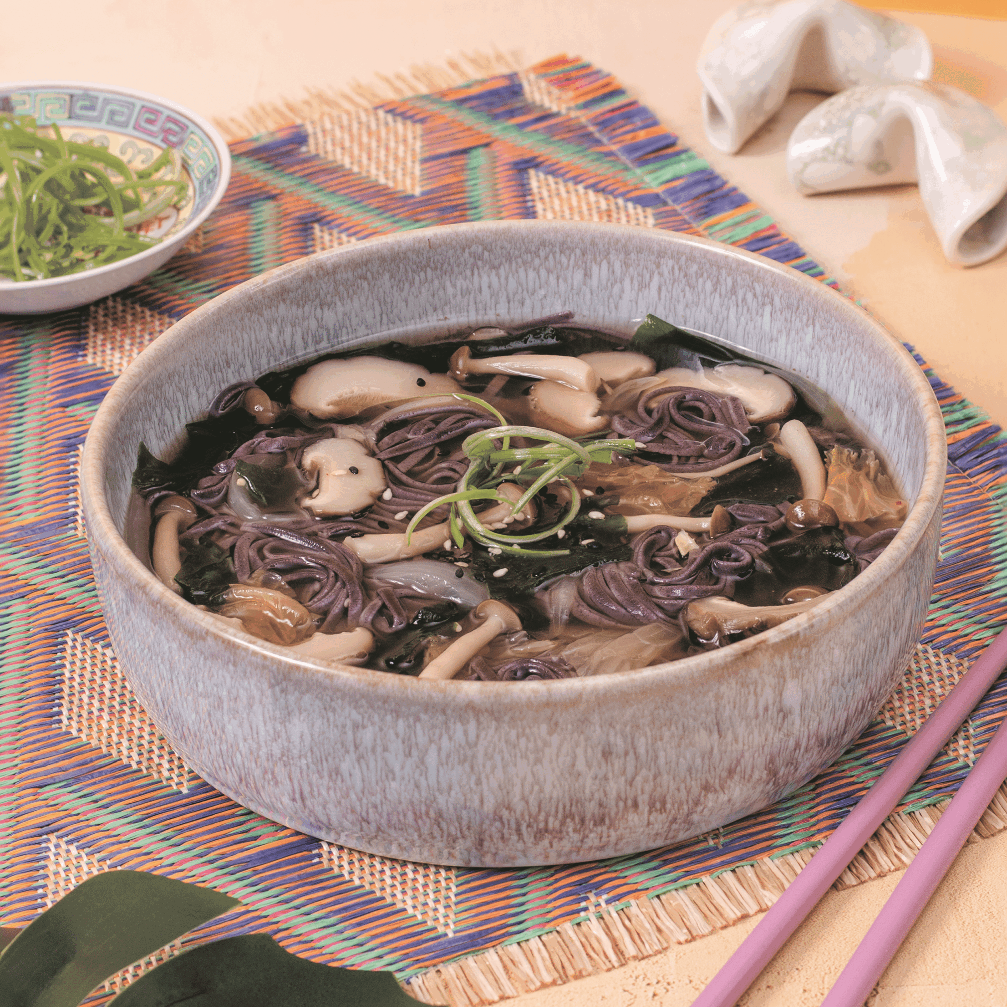 A bowl of miso soup with mushrooms.