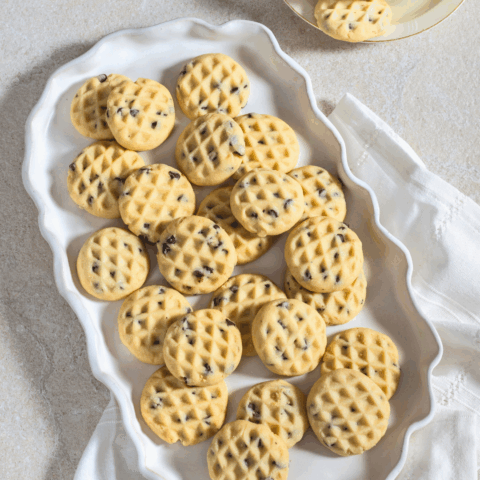 A white vintage platter of freshly-baked Stracciatella Shortbread Cookies