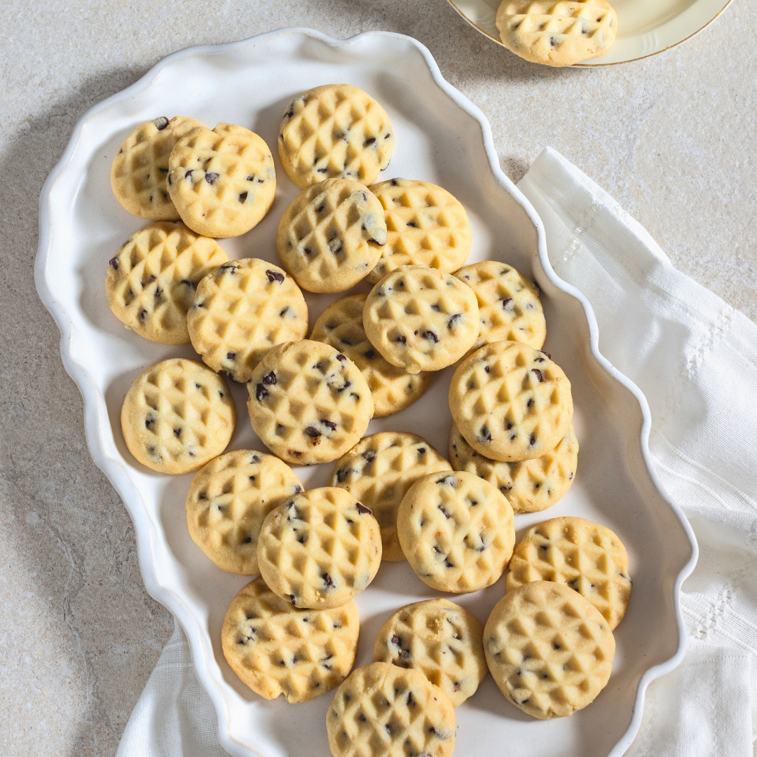A white vintage platter of freshly-baked Stracciatella Shortbread Cookies