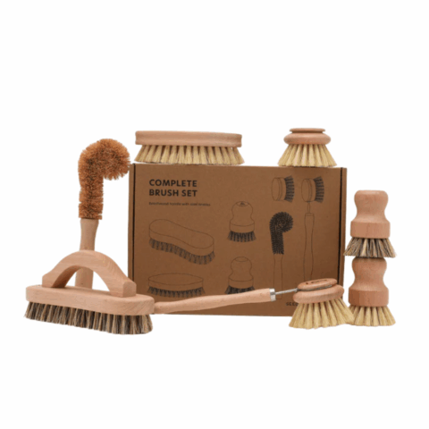 A brown box surrounded by a variety of brown wooden kitchen brushes.