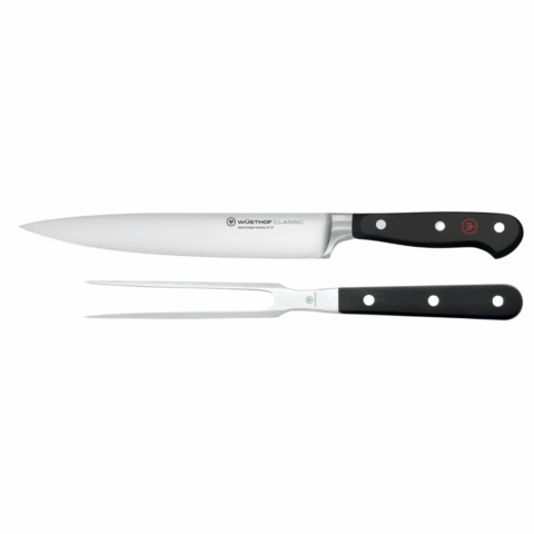 A carving knife and a carving fork with black handles.