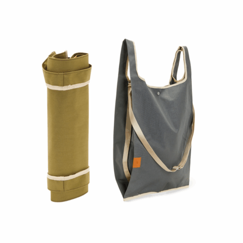 A rolled up green fabric tote bag beside a gray fabric tote bag.