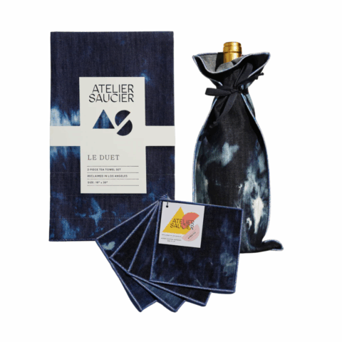 Matching set of blue table linens, cocktail napkins and bottle bag.