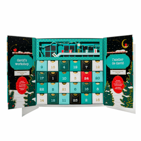 A teal advent calendar with 24 compartments filled with teabags.