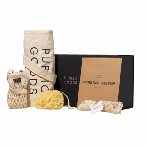 A black box, a brown card, a rolled up tote bag, a rolled up mesh bag, a sponge and a