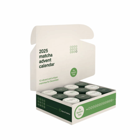 An open white and green box containing 12 mini jars of matcha.