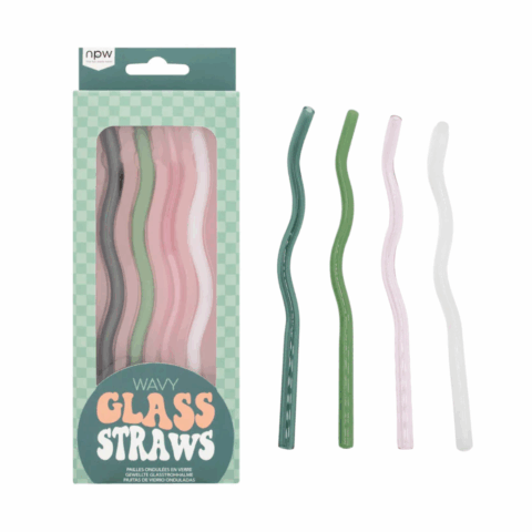 Four wavy glass straws next to a green package of four wavy glass straws.
