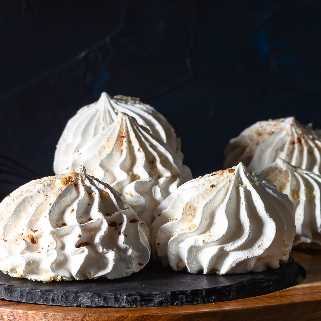 Chewy, fragrant, and easy 3-ingredient almond meringue cookies against a black background