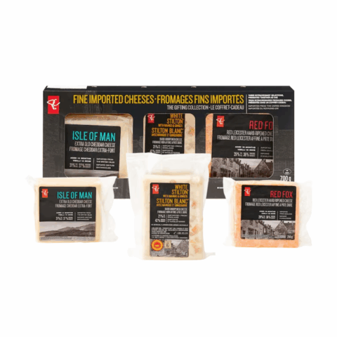 Three packaged cheeses in front of a black box.