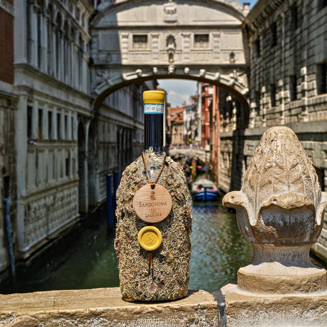 A bottle of Sansonina in Laguna in front of a canal in- Venice