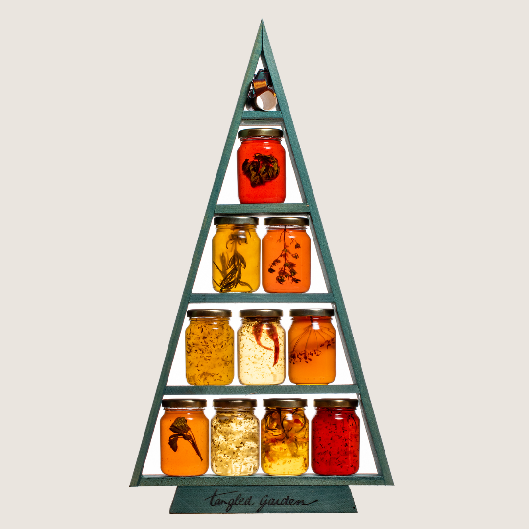 A wooden tree-shaped shelf holding ten jars of colourful preserves and jams across four levels.