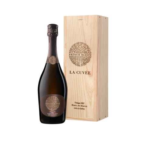 A dark bottle of non-alcoholic wine next to a wooden box.