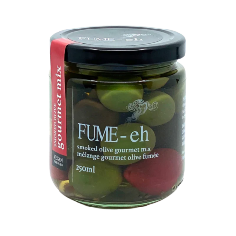 Clear jar of green and red olives in a brine.
