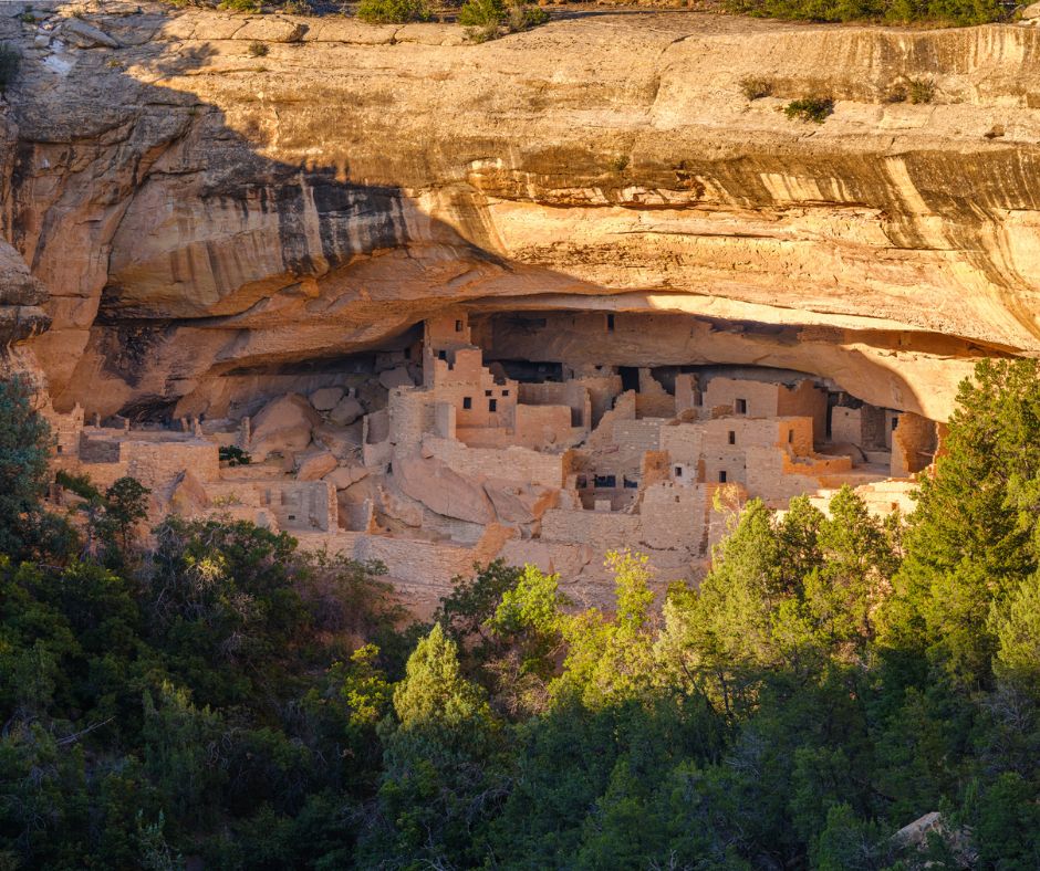 Ancient cliff dwellings built into sandstone rock walls at Mesa Verde National Park.