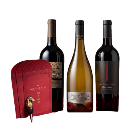 Three bottles of wine with a stack of red envelopes and a commemorative bronze horse wine stopper.