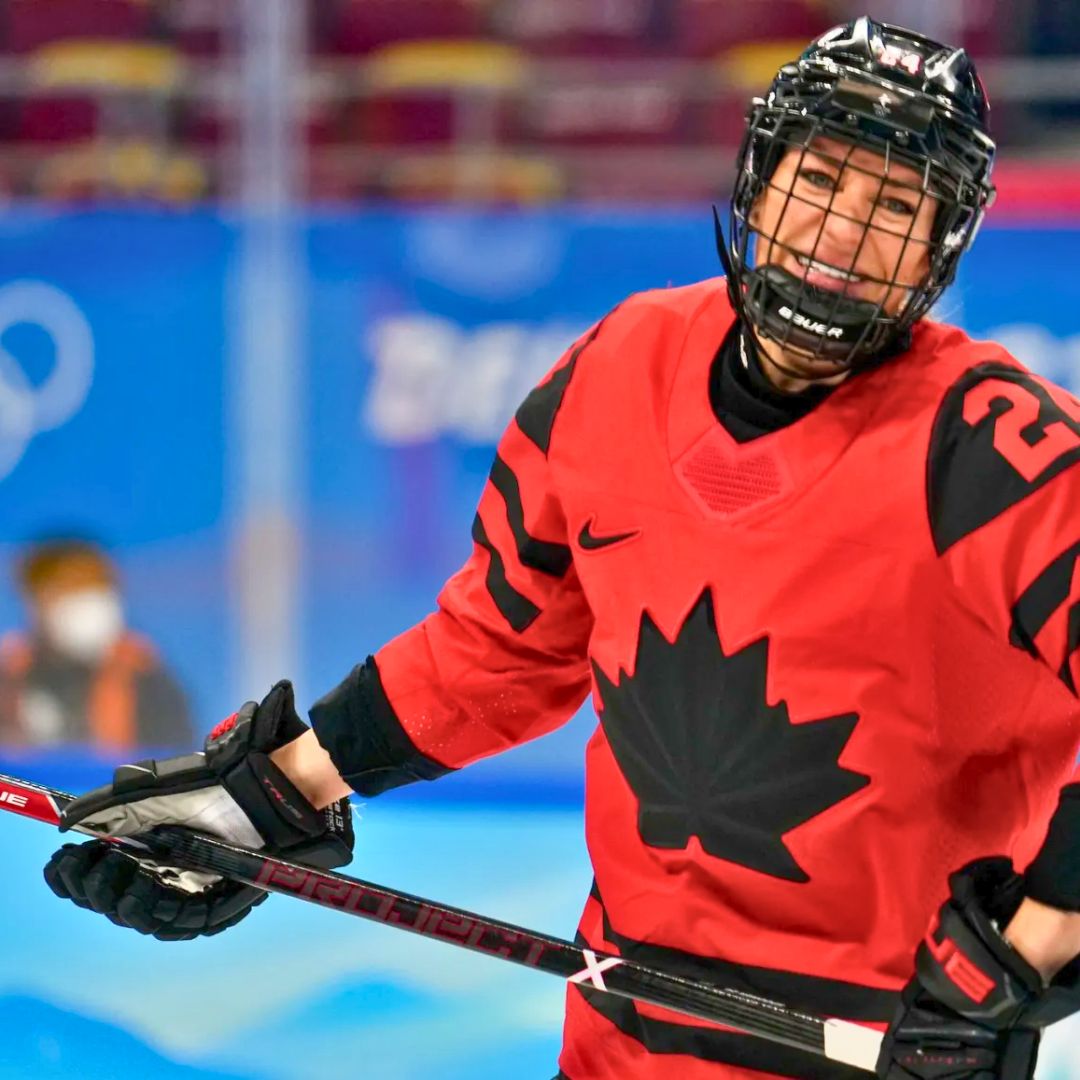 Natalie Spooner competing at the 2022 Winter Olympics in Beijing, China wearing her red Team Canada jersey