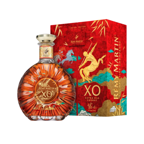 A bottle of amber-coloured XO cognac next to a decorative red box featuring a yellow centaur.