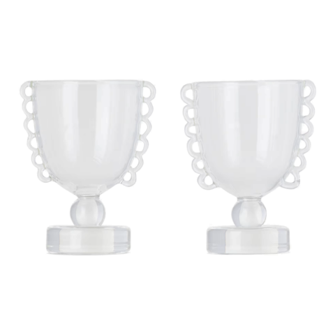 Two clear glass cups with a lace detail along the edge.