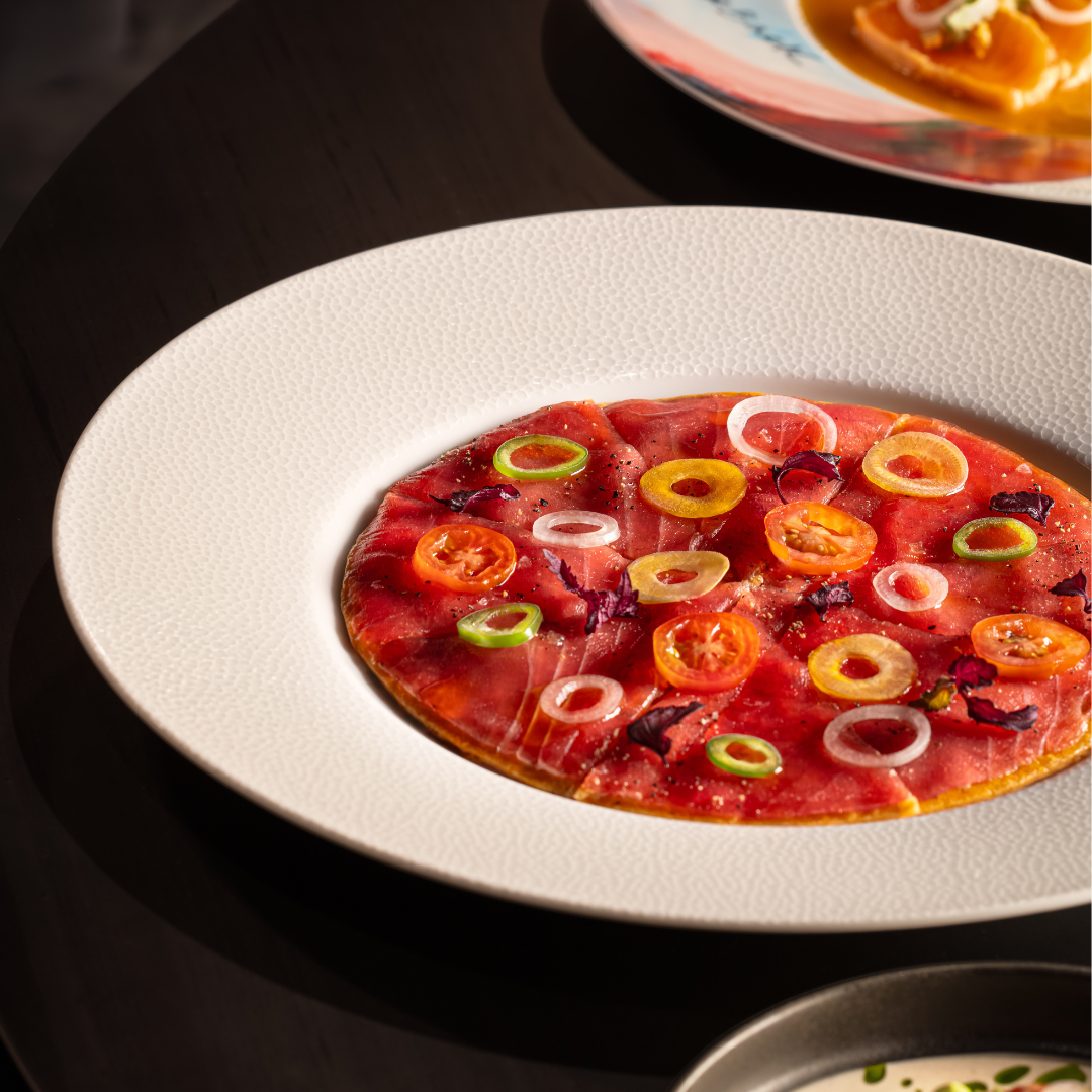 Crispy rice topped with thinly sliced tuna and peppers.