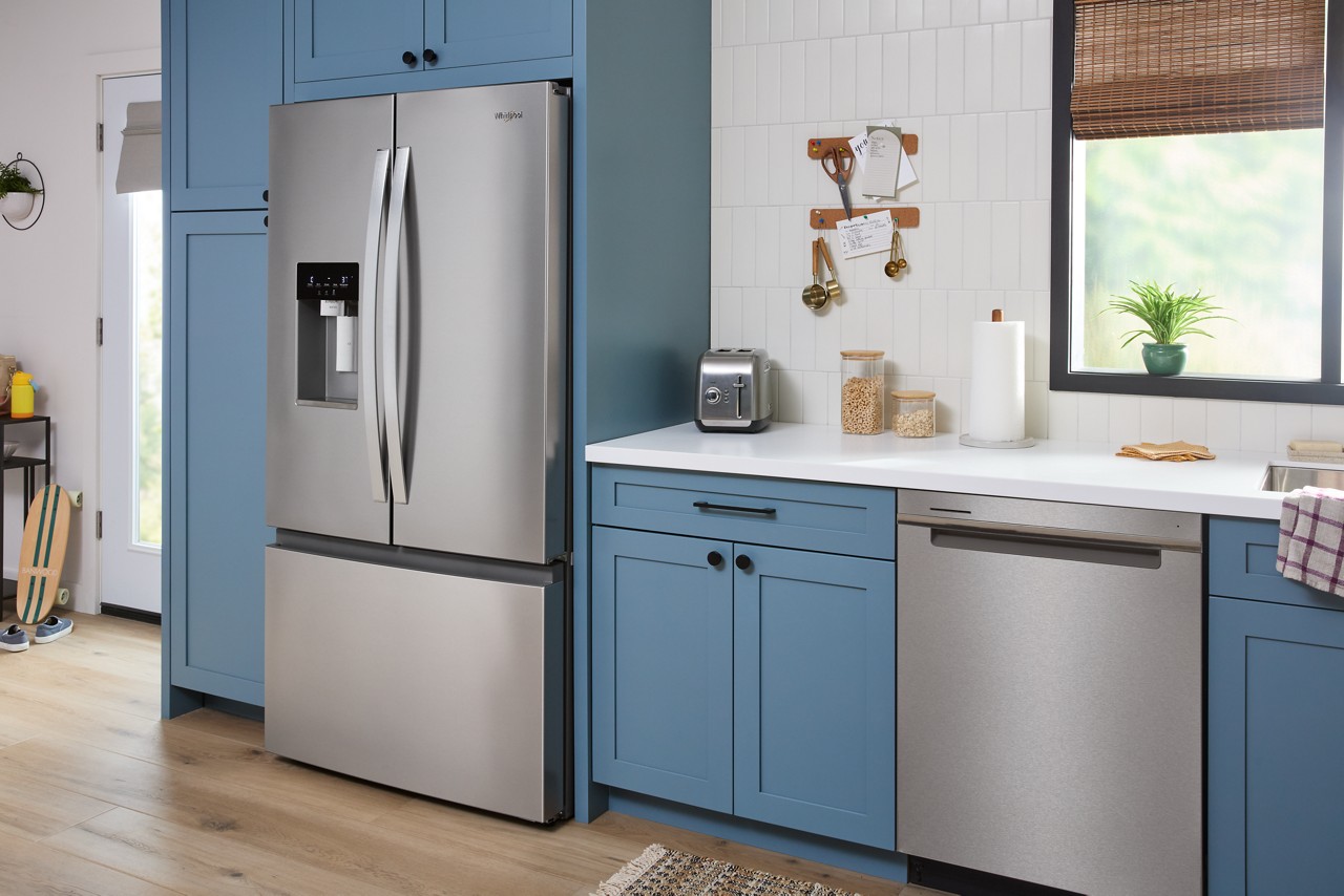 blue kitchen with new whirlpool appliances